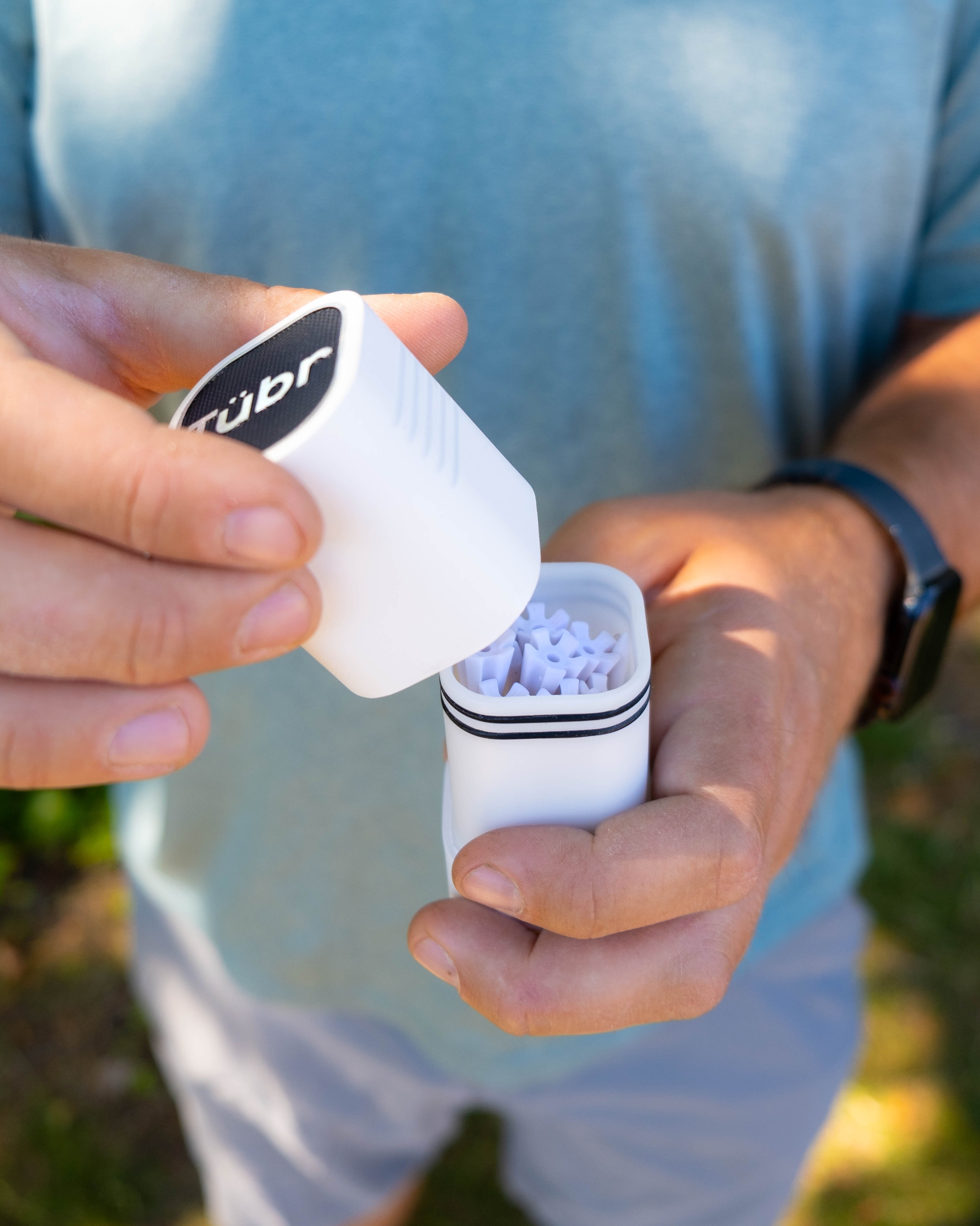Pocket-sized airtight waterproof stash box for storing cannabis, medication & valuables. White Frost with Golf Tees.